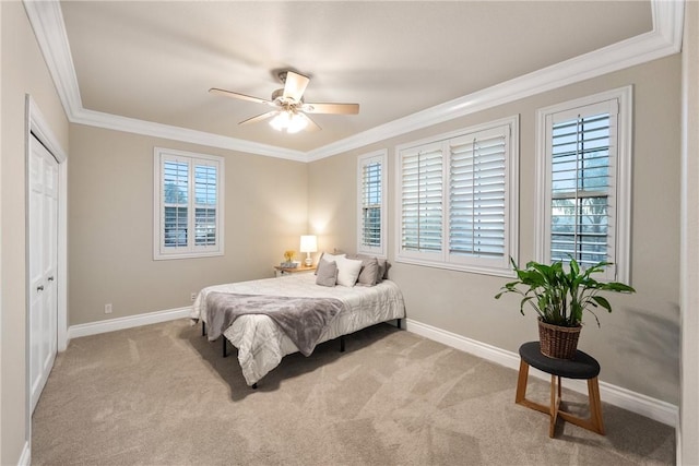 bedroom featuring baseboards, carpet, ornamental molding, and a ceiling fan