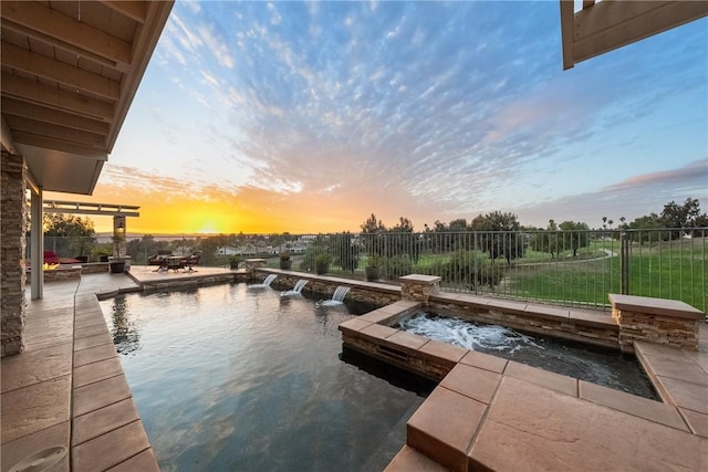 dock area featuring a patio area, a fenced in pool, an in ground hot tub, and a fenced backyard