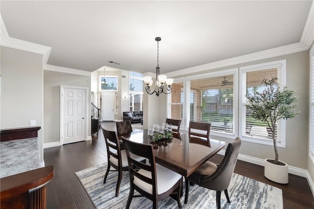 dining space featuring visible vents, baseboards, dark wood finished floors, and crown molding