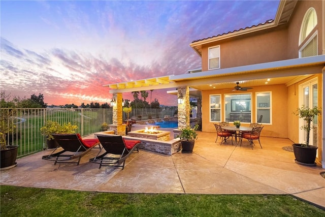 view of patio with fence, ceiling fan, and an outdoor fire pit