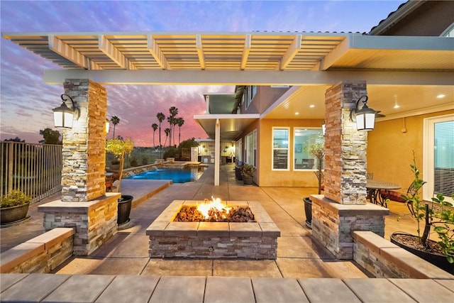 patio terrace at dusk with a fenced in pool, a fire pit, and a pergola