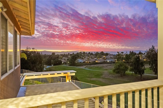 balcony at dusk featuring a mountain view