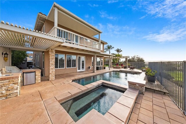 back of house featuring a fenced in pool, fence, a balcony, area for grilling, and an in ground hot tub