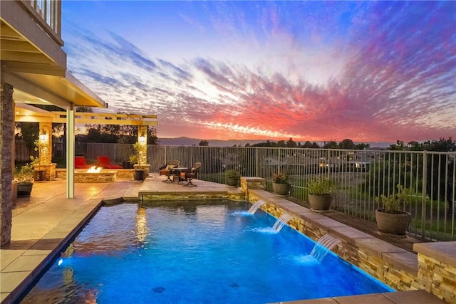 pool at dusk with a patio area, a fenced in pool, a fire pit, and fence