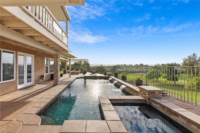 view of swimming pool featuring a patio area, a fenced in pool, an in ground hot tub, and fence