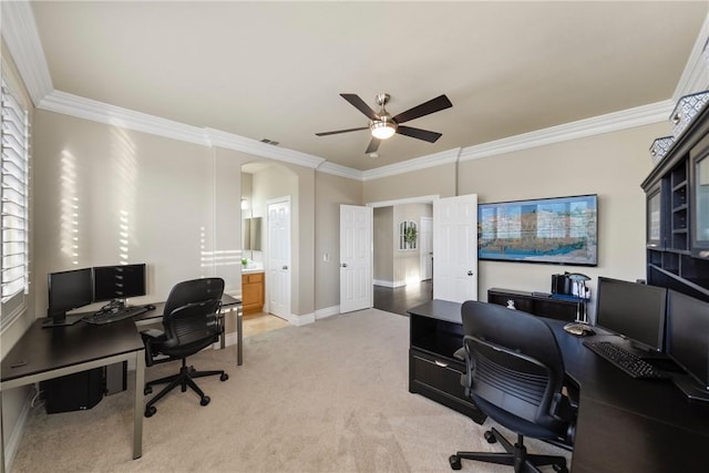 office space with visible vents, arched walkways, crown molding, baseboards, and light colored carpet