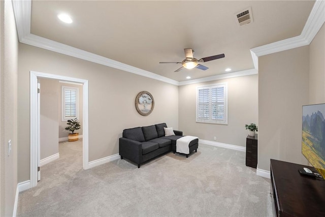 sitting room featuring light carpet, visible vents, baseboards, and ornamental molding