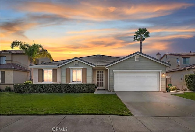 ranch-style house featuring driveway, a front lawn, an attached garage, and a tile roof