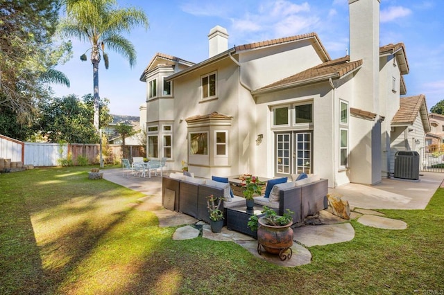 rear view of house with a patio, a fenced backyard, a chimney, an outdoor hangout area, and central AC