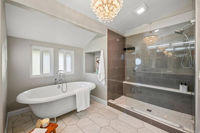 bathroom featuring a freestanding tub, a chandelier, vaulted ceiling, and tiled shower