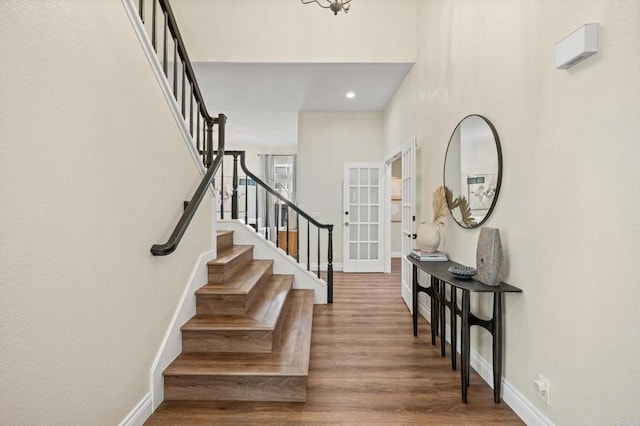 foyer entrance with stairs, recessed lighting, baseboards, and wood finished floors