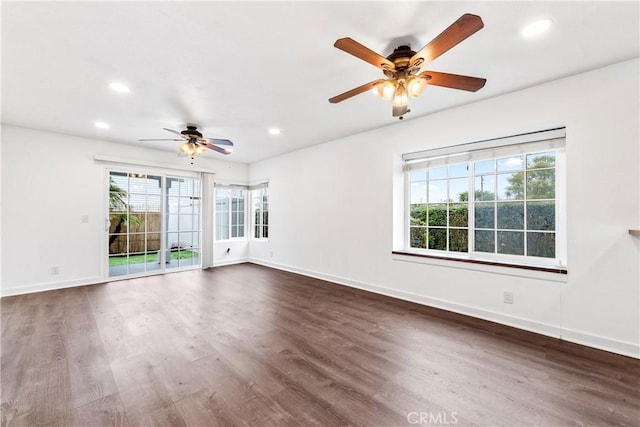 unfurnished room with ceiling fan, recessed lighting, dark wood finished floors, and baseboards