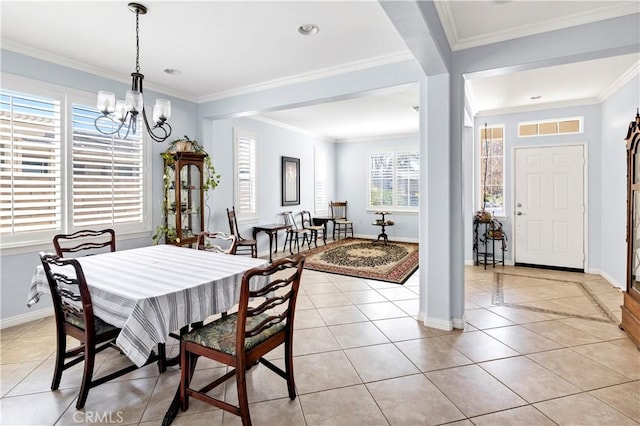 dining area featuring light tile patterned floors, a chandelier, visible vents, and crown molding