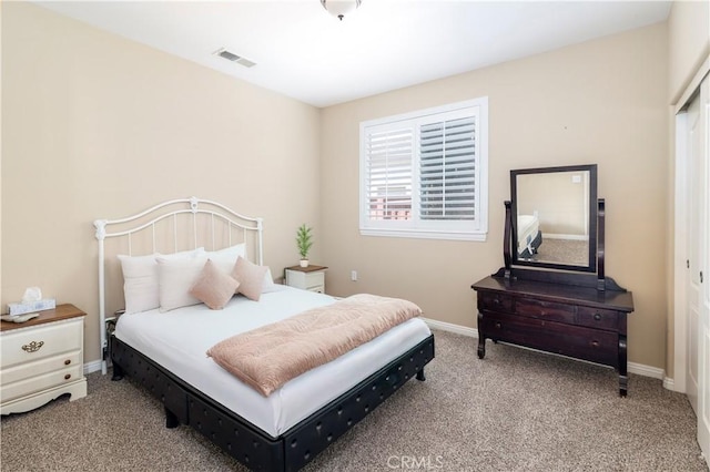 bedroom with carpet, visible vents, and baseboards