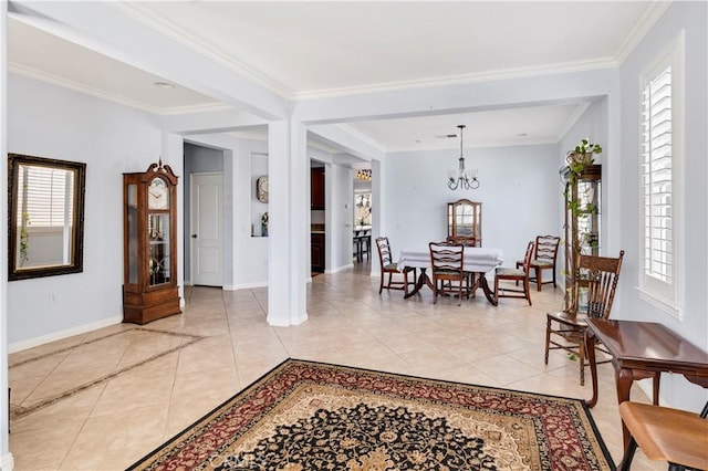 dining room featuring plenty of natural light, light tile patterned flooring, a chandelier, and crown molding