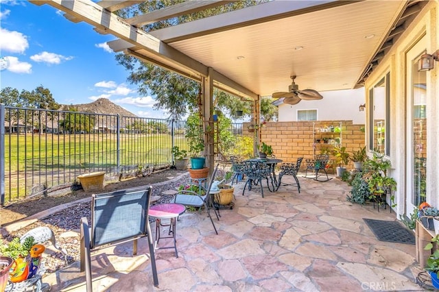 view of patio / terrace featuring a ceiling fan, fence, and a pergola