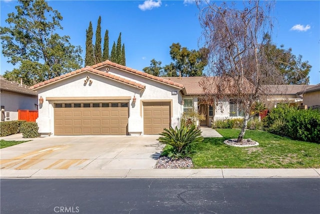 view of front of property with stucco siding, concrete driveway, an attached garage, a tiled roof, and a front lawn