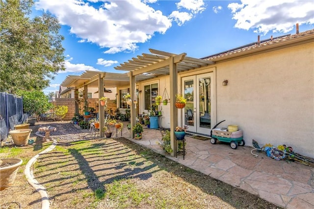 view of yard featuring a patio, fence, a pergola, and french doors