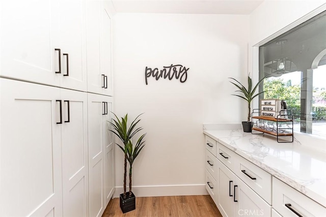 interior space with light wood-style flooring and baseboards