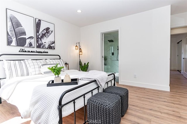 bedroom featuring light wood-style floors, baseboards, ensuite bathroom, and recessed lighting