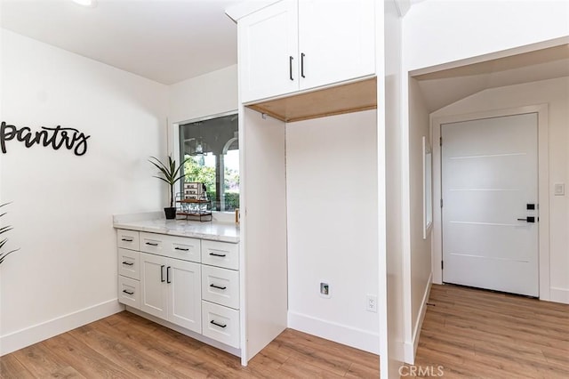 interior space featuring light wood finished floors and baseboards