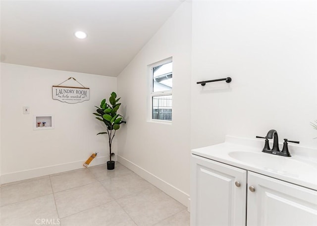 bathroom with tile patterned flooring, vanity, baseboards, and recessed lighting