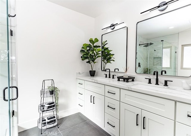 full bathroom featuring a stall shower, tile patterned flooring, a sink, and double vanity