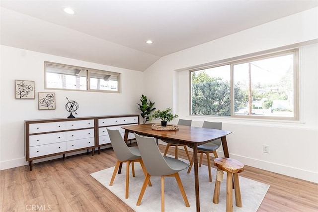 dining area with light wood-style floors, recessed lighting, vaulted ceiling, and baseboards