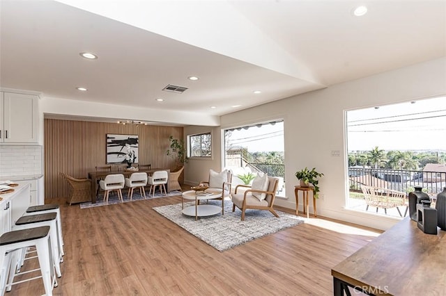 sitting room featuring light wood-style flooring, visible vents, baseboards, and recessed lighting