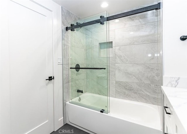 full bath with vanity and bath / shower combo with glass door