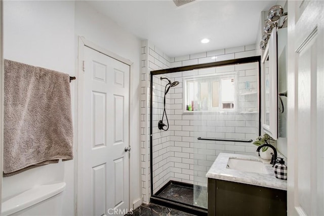 full bathroom featuring vanity, marble finish floor, a stall shower, and toilet