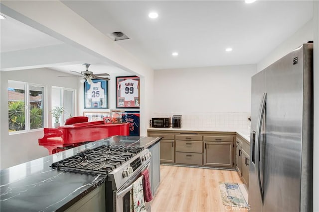 kitchen with ceiling fan, light wood finished floors, stainless steel appliances, recessed lighting, and tasteful backsplash