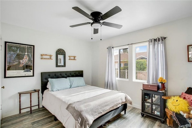 bedroom with baseboards, a ceiling fan, and wood finished floors