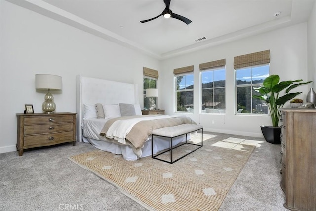 bedroom featuring ceiling fan, carpet floors, visible vents, and baseboards