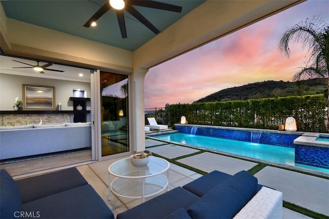 view of swimming pool featuring a fenced in pool, a patio area, a mountain view, fence, and an in ground hot tub