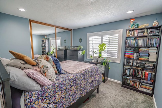 bedroom with carpet, baseboards, a textured ceiling, and recessed lighting