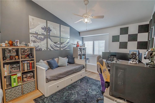 bedroom featuring lofted ceiling, wood finished floors, and a ceiling fan