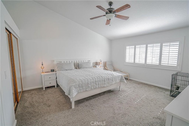 carpeted bedroom with vaulted ceiling, ceiling fan, a closet, and baseboards