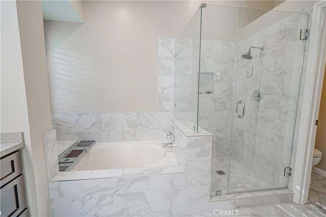 bathroom featuring a stall shower, vanity, toilet, and a bath