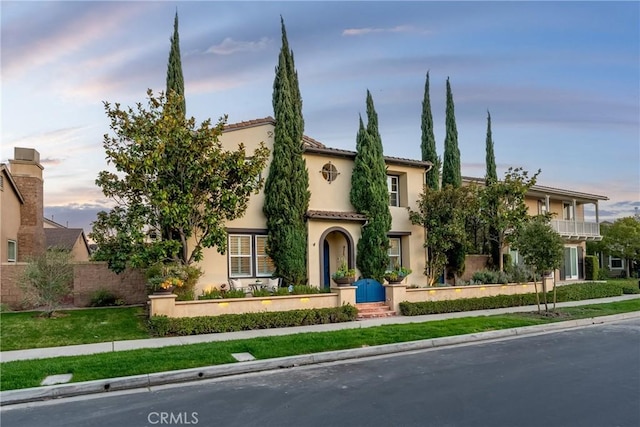 mediterranean / spanish-style house with a tile roof and stucco siding