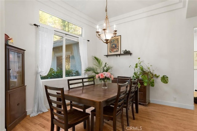 6356 Hidden Lake Ln, Magalia, CA 95954 - dining area featuring baseboards, light wood finished floors, a chandelier, and a wealth of natural light