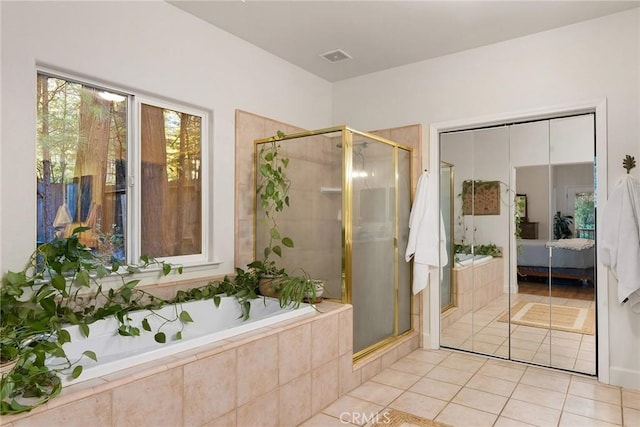 ensuite bathroom featuring ensuite bath, a shower stall, a garden tub, and tile patterned floors