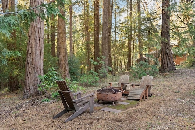 view of yard with a fire pit