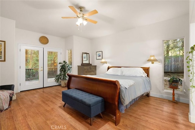 6356 Hidden Lake Ln, Magalia, CA 95954 - bedroom with light wood-style floors, multiple windows, and access to exterior