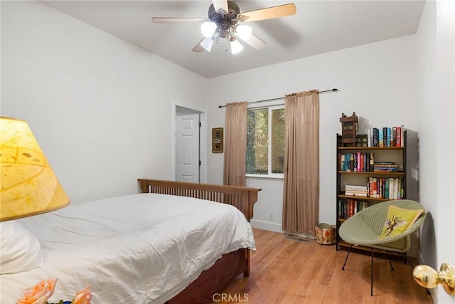 bedroom featuring a ceiling fan and wood finished floors