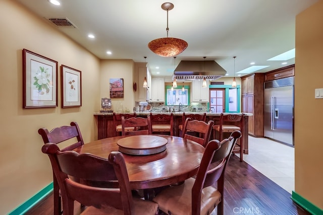 dining space featuring recessed lighting, visible vents, and wood finished floors