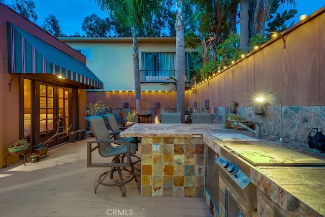 view of patio / terrace featuring outdoor wet bar, an outdoor kitchen, and french doors