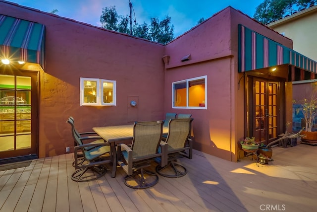 wooden deck featuring french doors and outdoor dining area