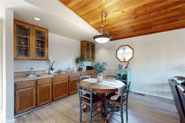 dining room featuring wooden ceiling, recessed lighting, baseboards, vaulted ceiling, and light wood-style floors