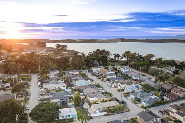 birds eye view of property with a water view and a residential view